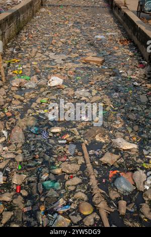 I rifiuti di plastica di vari tipi coprono un canale a Dacca, Bangladesh, evidenziando una questione ambientale urgente. Foto Stock