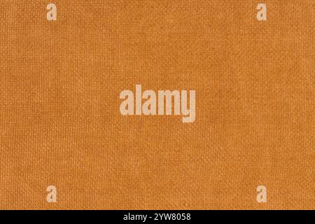 Mano in tessuto di colore marrone chiaro motivo astratto per lo sfondo. Foto ravvicinata del materiale del tessuto a livello di superficie di colore arancione, sfondo colorato Foto Stock
