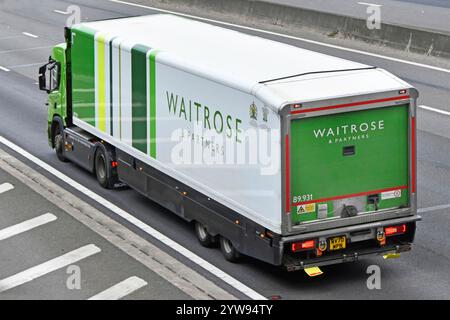 Vista posteriore laterale aerea del supermercato Waitrose, vendita al dettaglio e catena di approvvigionamento alimentare online, consegna camion e rimorchio guida autostrada M25 Regno Unito Foto Stock