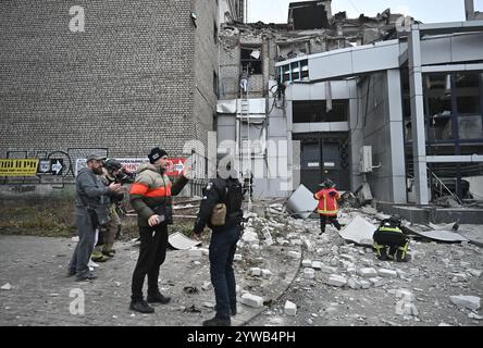 Zaporizhzhia, Ucraina. 10 dicembre 2024. ZAPORIZHZHIA, UCRAINA - 10 DICEMBRE 2024 - le persone sono fuori da un edificio distrutto da un attacco missilistico russo, Zaporizhzhia, Ucraina sudorientale. Tre persone sono morte e almeno 14 sono ferite. Un edificio per uffici, un centro medico e altri edifici sono danneggiati. Potrebbero esserci persone sotto le macerie. Crediti: Ukrinform/Alamy Live News Foto Stock