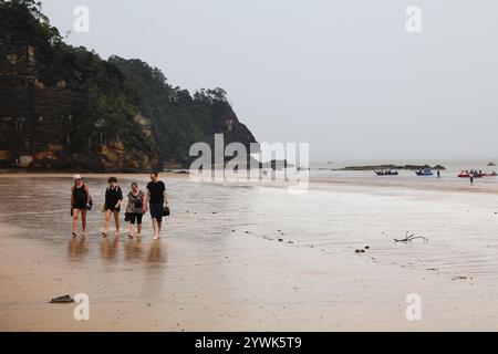 PARCO NAZIONALE DI BAKO, MALESIA - 9 MARZO 2024: I turisti arrivano in barca sulla spiaggia del Parco nazionale di Bako, nello stato di Sarawak, nell'isola del Borneo, Malesia. Foto Stock