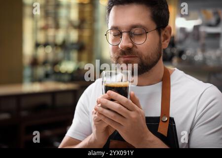 Il barista annusa caffè aromatico al caffè Foto Stock