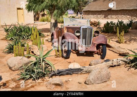 Una vecchia auto completamente arrugginita nella sabbia di un deserto, i relitti di Solitare, Namibia Foto Stock