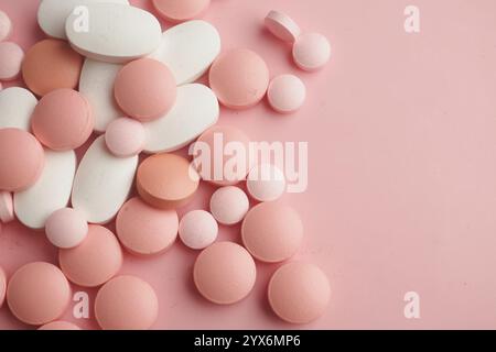 Un variopinto assortimento di varie pillole e tablet su sfondo rosa Foto Stock