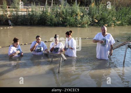 Le donne e gli uomini ortodossi rumeni si attraversano e pregano nel fiume Giordano dove Giovanni Battista Battista battezzò Gesù Cristo. Foto Stock