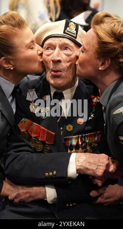 PA REVIEW OF THE YEAR 2024 file Photo datato 26/04/24: Il veterano del D-Day Alec Penstone, 98, che ha servito con la Royal Navy, riceve un bacio dai Darlings del D-Day all'evento di lancio del D-Day 80 organizzato dallo Spirit of Normandy Trust, in collaborazione con il British Normandy Memorial, presso l'Union Jack Club di Londra. L'evento è uno dei più grandi raduni britannici di veterani del D-Day e della Normandia per molti anni e riunisce alcuni degli ultimi membri rimasti di quella che è conosciuta come la più grande generazione. Data di pubblicazione: Lunedì 16 dicembre 2024. Foto Stock