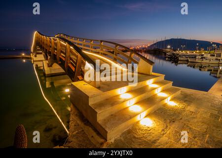 Ponte illuminato e viali sul lungomare nel resort di Lefkada sull'isola di Lefkada Foto Stock