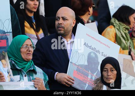 Tunisi, Tunisia, 18 dicembre 2024. Attivisti e manifestanti si riuniscono fuori dal teatro in viale Habib Bourguiba chiedendo diritti per i migranti che intraprendono il pericoloso attraversamento del Mediterraneo per raggiungere l'Italia e l'Europa. I partecipanti hanno denunciato il trattamento dell'Italia nei confronti dei migranti irregolari che raggiungono le sue coste, gli accordi della Tunisia con l'Italia e l'UE per arginare il flusso di arrivi irregolari in Europa e il "nuovo Patto sull'immigrazione e l'asilo” dell'UE. La manifestazione ha coinciso con la giornata internazionale dei migranti Foto Stock