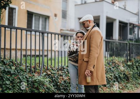 Giovani coppie che esplorano una città insieme all'aperto in una giornata fredda Foto Stock