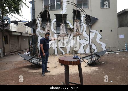 Kolkata, India. 20 dicembre 2024. Un uomo tiene un'installazione artistica all'interno di un vicolo durante un festival d'arte all'aperto, il Behala Art Fest, a Kolkata, India, il 20 dicembre 2024. (Foto di Rupak De Chowdhuri/NurPhoto) crediti: NurPhoto SRL/Alamy Live News Foto Stock