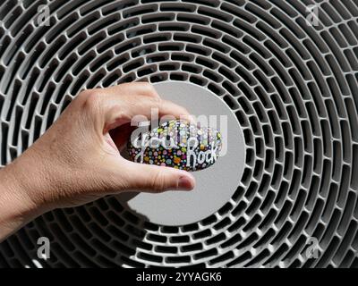 Sulla parte superiore dell'unità HVAC con la gentilezza della roccia tenuta in mano Foto Stock