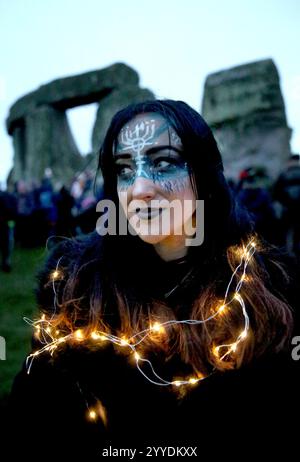 Salisbury, Inghilterra, Regno Unito. 21 dicembre 2024. Uno di quelli che si trovano alle pietre durante le celebrazioni del solstizio d'inverno indossa un elaborato trucco e un scialle di luci fiabesche. Il solstizio d'inverno 2024 segna sia il giorno più breve che la notte più lunga dell'anno. Il Solstizio segna anche l'inizio dello storico festival pagano, Yule. Stonehenge fu costruita per allinearsi al sole sui solstizi. (Credit Image: © Martin Pope/ZUMA Press Wire) SOLO PER USO EDITORIALE! Non per USO commerciale! Foto Stock