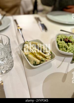 fava tradizionale con olio d'oliva. Antipasto fava con fave schiacciate sul tavolo della cena Foto Stock