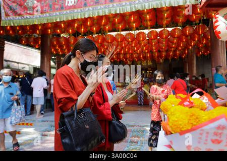 Bangkok, Thailandia - 21 gennaio 2023: Le donne pregano nel tempio durante le celebrazioni del Capodanno lunare cinese, l'anno del Coniglio, a Chinatown. Foto Stock