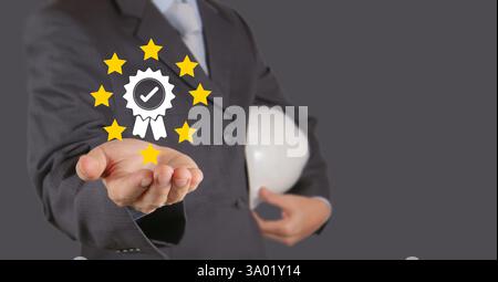 Mano d'affari che mostra le idee garanzia, standard internazionale, certificazione di qualità ISO e marchio di garanzia di qualità, eccellente accreditamento nell'indu Foto Stock