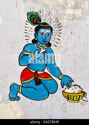 Murale di Bala Krishna a Varanasi, India, raffigurante la divinità del bambino che mangia burro, un popolare motivo indù che simboleggia giocosità divina e devozione. Foto Stock