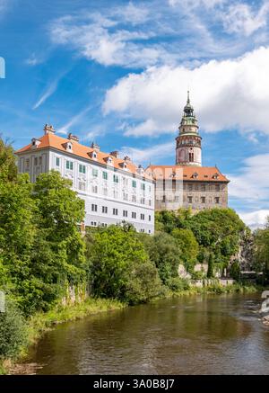 Vista del castello di Český Krumlov con torre, edifici con facciata colorata, fiume Moldava e vegetazione in una giornata di sole, Cesky Krumlov, Repubblica Ceca Foto Stock