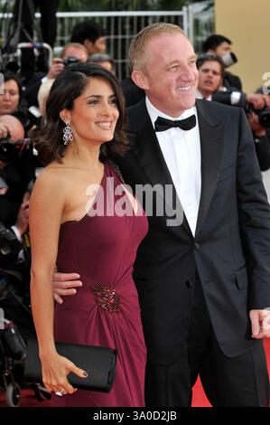 SALMA HAYEK & FRANCOIS PINAULT .wearing Gucci.At the opening ceremony and screening of 'Robin Hood' presented out of competition at the 63rd Cannes Film Festival, Cannes, France, .12th May 2010..arrivals half length burgundy maroon red one shoulder dress slit cut out beaded married husband wife couple black bow tie tuxedo tux side smiling clutch bag .CAP/PL.©Phil Loftus/Capital Pictures. Foto Stock