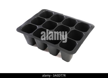 Contenitori commerciali per la coltivazione di materie plastiche per giovani piante. Foto Stock
