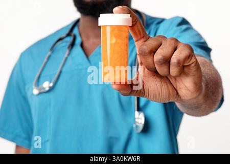 Un terapista afroamericano che raccomanda pillole, primo piano Foto Stock