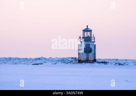 In inverno, il fiume San Lorenzo ghiacciato al livello del lago Saint-Pierre con il faro di fronte al Parc Écomareles de l'Anse-du-Port Foto Stock