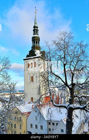 Vista ravvicinata della torre della chiesa di San Nicola e dei tetti innevati della città vecchia di Tallinn, Estonia Foto Stock
