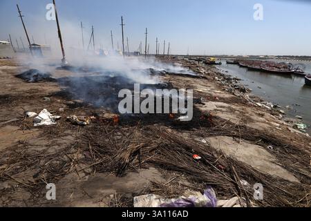 Prayagraj, India. 6 marzo 2025, i lavoratori bruciano spazzatura dopo la conclusione di Maha Kumbh Mela 2025, sulla riva del Sangam, confluenza del fiume Gange, Yamuna e il mitico Saraswati a Prayagraj, Uttar Pradesh, giovedì. Crediti: Anil Shakya/Alamy Live News Foto Stock