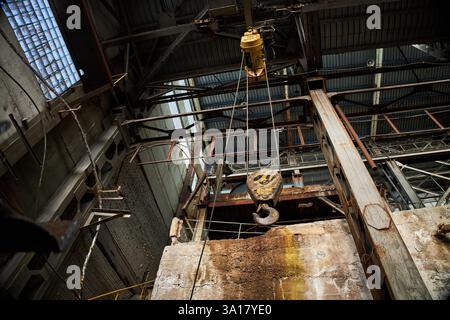 gancio per gru industriale sporco, fabbrica abbandonata Foto Stock