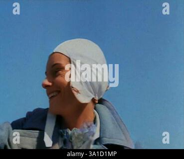 Jean Batten in Flying Gear sorridente alla folla, anni '1930 Da "Time to Remember - Some People in the Thirties", anni '1930 (Reel 2); film documentario sugli anni '1930, incentrato su personaggi famosi dell'epoca. (Fermo bianco e nero colorato) Foto Stock