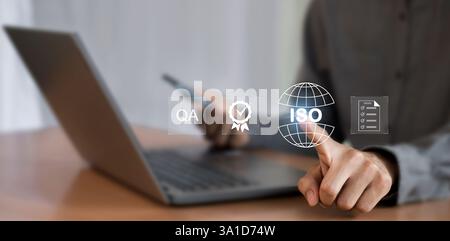 Simbolo ISO uomo d'affari che mostra il controllo della qualità sullo schermo virtuale Foto Stock