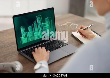 Modellazione delle informazioni di costruzione. Donna che lavora al portatile in casa, primo piano. Progetto digitale sul display del computer Foto Stock