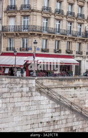 Un accogliente caffè parigino, dove il tempo rallenta con una tazza di caffè caldo. Foto Stock