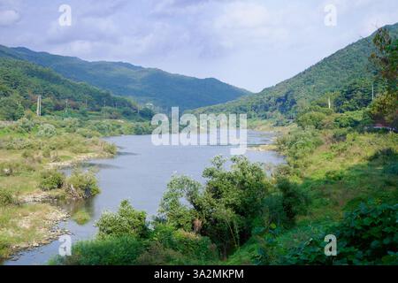 Contea di Gokseong, Corea del Sud - 3 ottobre 2021: Una vista serena del fiume Seomjin che si snoda attraverso lussureggianti montagne verdi, offrendo un paesaggio pittoresco Foto Stock