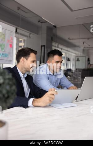 Due diversi colleghi d'affari che lavorano insieme al notebook Foto Stock