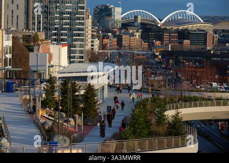 Seattle, Washington, Stati Uniti. 16 marzo 2025. I visitatori camminano lungo la nuova passeggiata panoramica di Seattle al tramonto. Il progetto di riqualificazione del lungomare di Seattle, che include una passeggiata nel parco, piste ciclabili e nuove piazze pubbliche, dovrebbe essere completato nel corso dell'anno. Crediti: Paul Christian Gordon/Alamy Live News Foto Stock