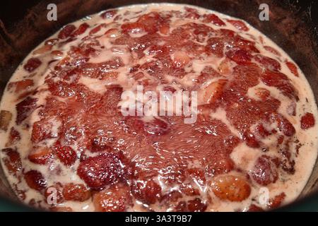 Marmellata di fragole bollente nella pentola Foto Stock