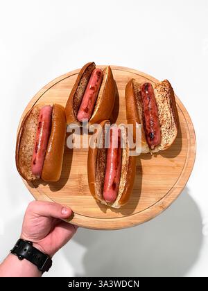 Traditional hot dog with sausage grilled on the barbecue Foto Stock