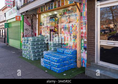 Mini-market o minimarket con casse di acqua minerale all'aperto a Selly Oak, Birmingham Foto Stock