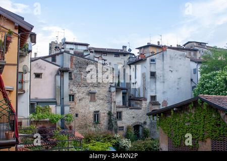 Dettagli architettonici in un vecchio ambiente urbano. Edifici in pietra, facciate chiare, balconi e tetti Foto Stock