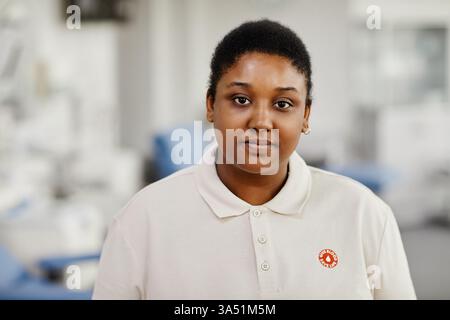 Ritratto di una giovane donna nera in un centro di donazione del sangue, con un adesivo Save Life e guardando la fotocamera. Questa immagine che dà potere comunica assistenza sanitaria, donazioni di beneficenza e l'importanza della donazione di sangue. Adatto per campagne, cliniche e funzioni di raccolta fondi. Foto Stock