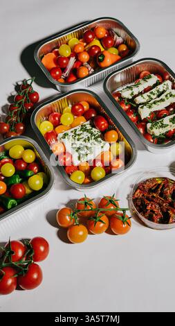 Una varietà di frutta e verdura è esposta in quattro diversi contenitori. I contenitori sono disposti in modo che sembrino pronti Foto Stock
