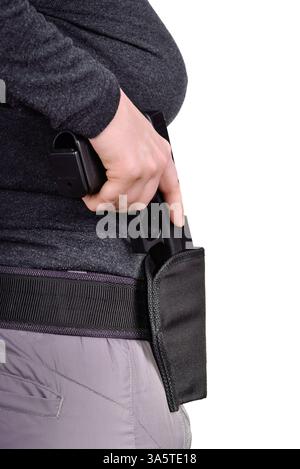 La vista laterale ravvicinata delle donne mette la pistola nella custodia su uno sfondo bianco Foto Stock