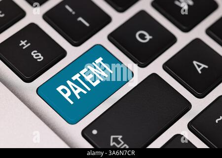 Licenza. Tastiera per laptop con brevetto Word su pulsante azzurro, primo piano Foto Stock