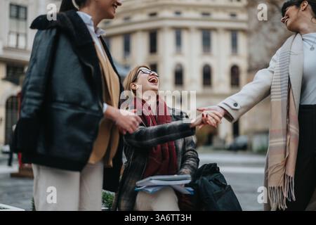 Tre donne che condividono risate e connessioni all'esterno in un ambiente urbano Foto Stock