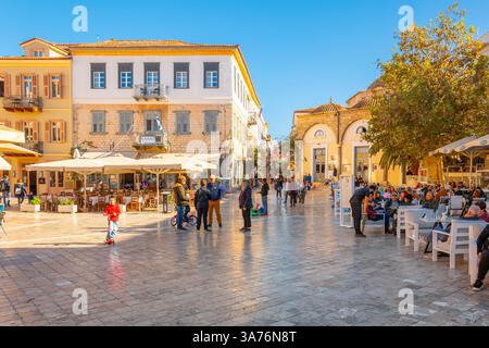 I greci e i turisti possono godersi una giornata di sole in autunno a Piazza Syntagma, nella storica città vecchia di Nauplia, in Grecia. Foto Stock