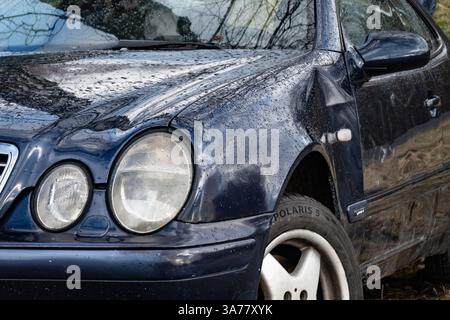PETRVALD, CECHIA - 26 GENNAIO 2024: Fari rotondi della vettura Mercedes-Benz CLK Coupé W208 con parafango danneggiato Foto Stock