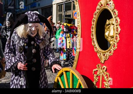 Le persone mascherate celebrano il tipico carnevale di Lucerna nelle strade della città. Foto Stock