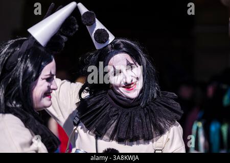 Le persone mascherate celebrano il tipico carnevale di Lucerna nelle strade della città. Foto Stock