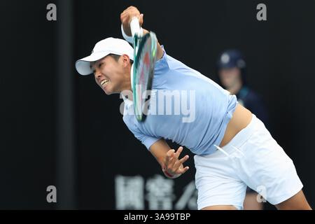 Il tennista americano Learner Tien (USA) gioca un tiro di servizio all'Australian Open 2025 Tournament, Melbourne Park, Melbourne, Victoria, Austral Foto Stock