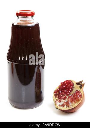 Bottiglia di succo di frutta e mature granata pezzo su sfondo bianco Foto Stock